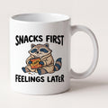 Snacks First Feelings Later Raccoon Funny Mug mug, front view